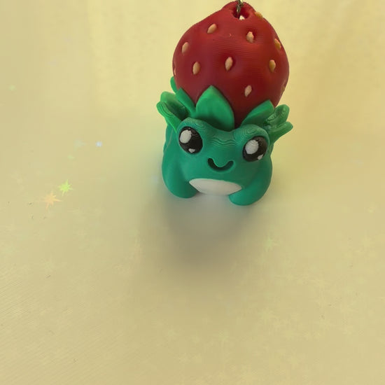 Strawberry hat frog keychain fidget clicker 3D printed teal frog wearing strawberry