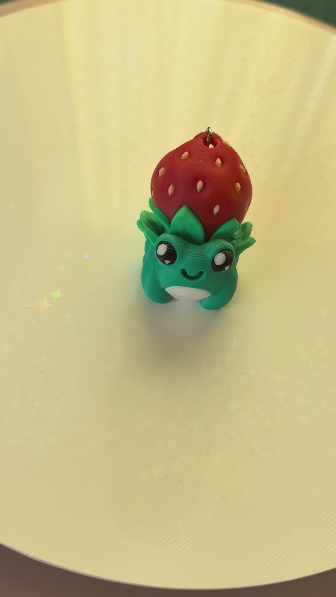 Strawberry hat frog keychain fidget clicker 3D printed teal frog wearing strawberry
