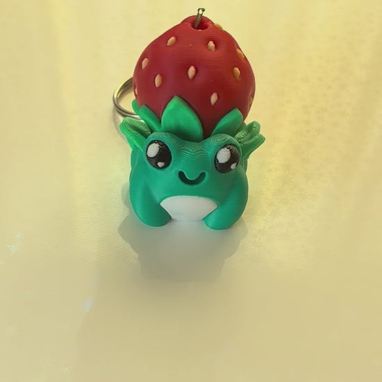 Strawberry hat frog keychain fidget clicker 3D printed teal frog wearing strawberry