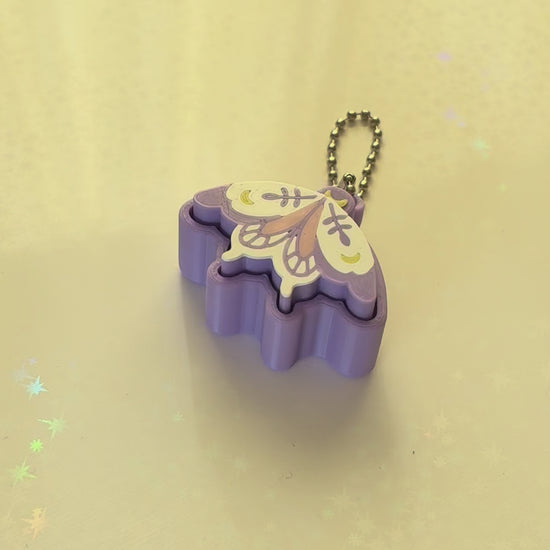 Pixie moth fidget clicker keychain 3D printed lavender with moon and botanical wing details pastel goth
