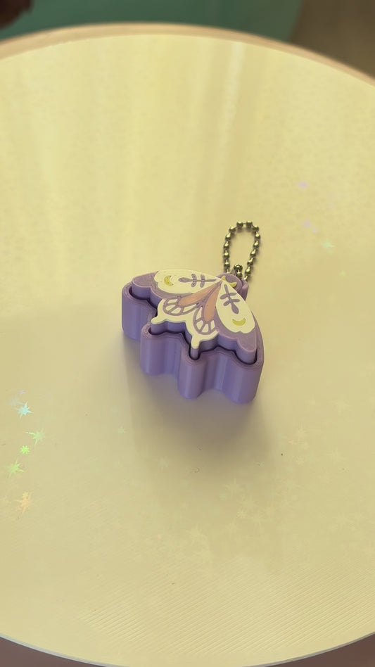 Pixie moth fidget clicker keychain 3D printed lavender with moon and botanical wing details pastel goth